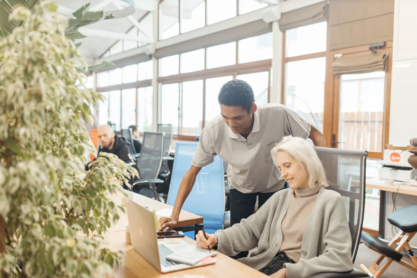 A diverse team working together in a modern office space, showcasing teamwork and collaboration. 25 coworking spaces to watch worldwide in 2027