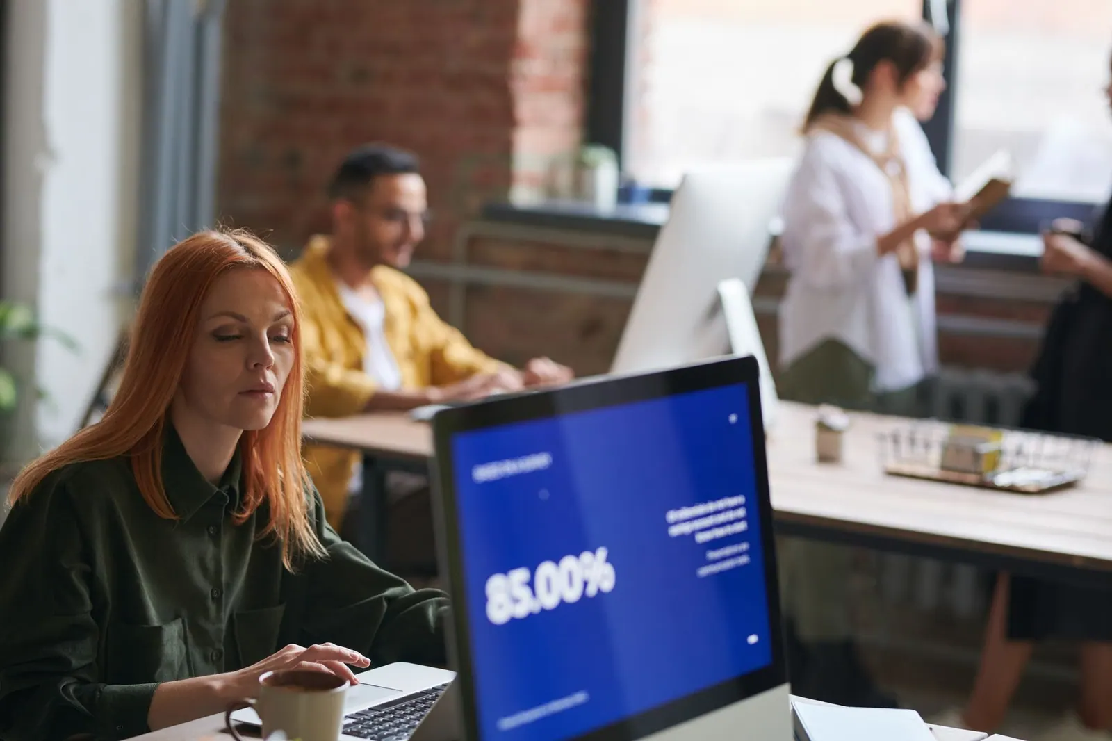 Professionals working in a stylish coworking space, focusing on growth and collaboration. Best coworking space software for 2027: 12 reviewed