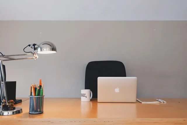 office, desk, wood, stationary, pencils, pens, lamp, coffee, cup, mug, notepad, macbook, laptop, computer, technology, business, coffee cup, gray business, gray computer, gray office, gray technology, gray coffee, gray laptop, gray wood, gray desk, gray company, gray cup, gray lamp. Coworking space equipment checklist, from essential to optional