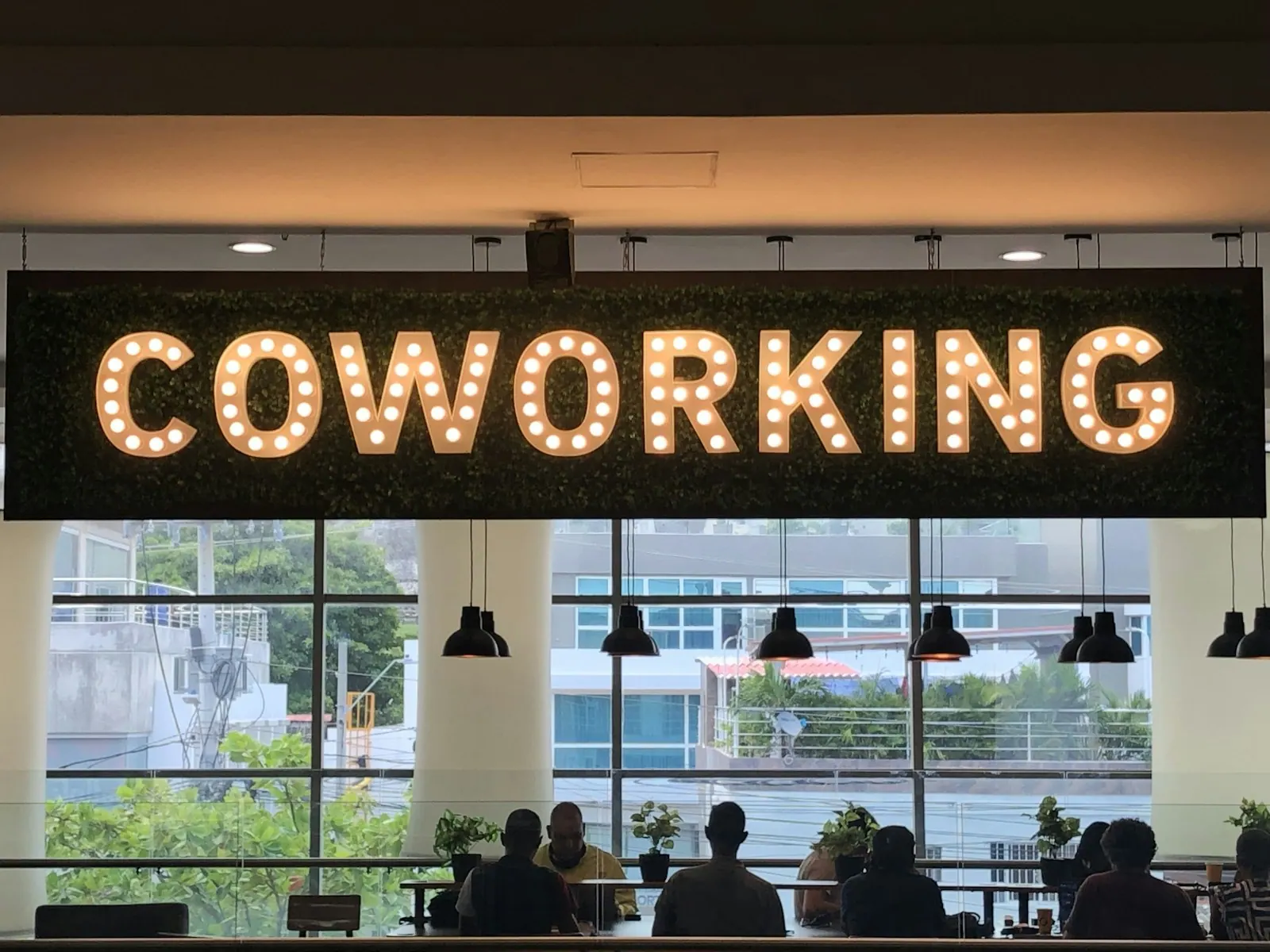 a restaurant with a sign Coworking space in a mall in Cartagena. Coworking space hiring and training guide