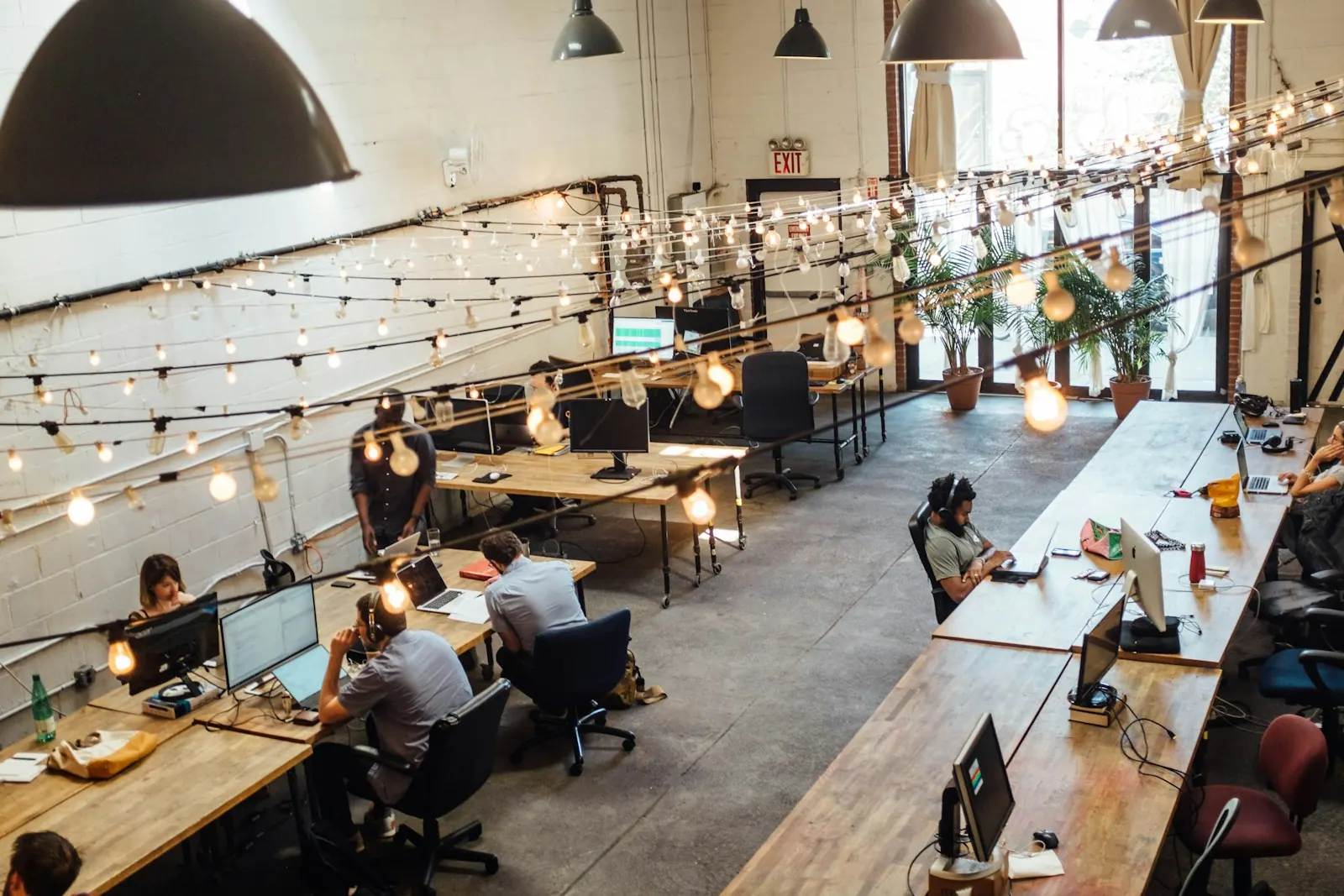people sitting in front of computer monitors Taking during a brief stint as a member at one of Brooklyn's coolest coworking spaces, Bat Haus (https://www.bathaus.com/). Friendly co. Coworking space licensing and compliance guide