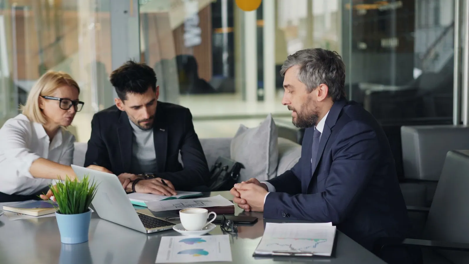 Diverse team of professionals having a business meeting in a modern office space. Coworking space profit margins and break-even points