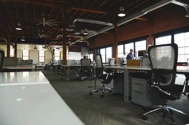 Open-plan industrial coworking space with modern design and natural lighting. Coworking space site selection and location guide for 2027