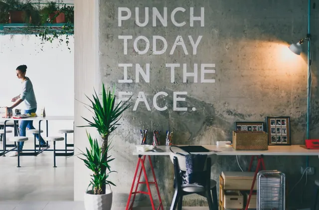 A person standing at a table in a workspace with a concrete wall In the small city of Split, Croatia, situated along the Dalmatian Coast, there’s a co-working space that was purpos. Coworking space SOP checklist for daily operations