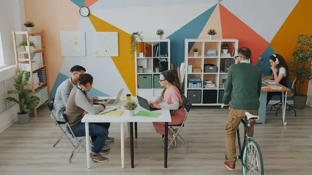 Diverse team collaborating in a vibrant modern coworking space, fostering creativity. How to win more coworking space members in 2027